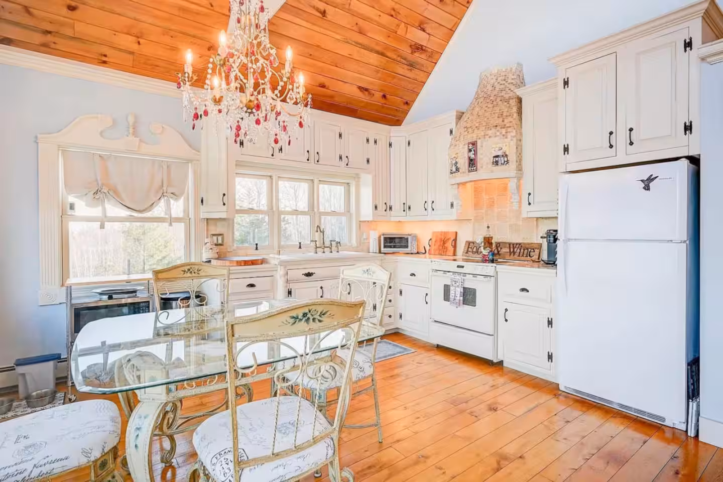 Warm chalet kitchen and dining area with soapstone counters and a long table
